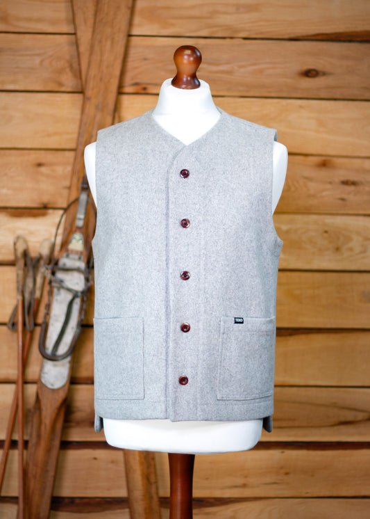 Gray vest on a mannequin against a wooden background
