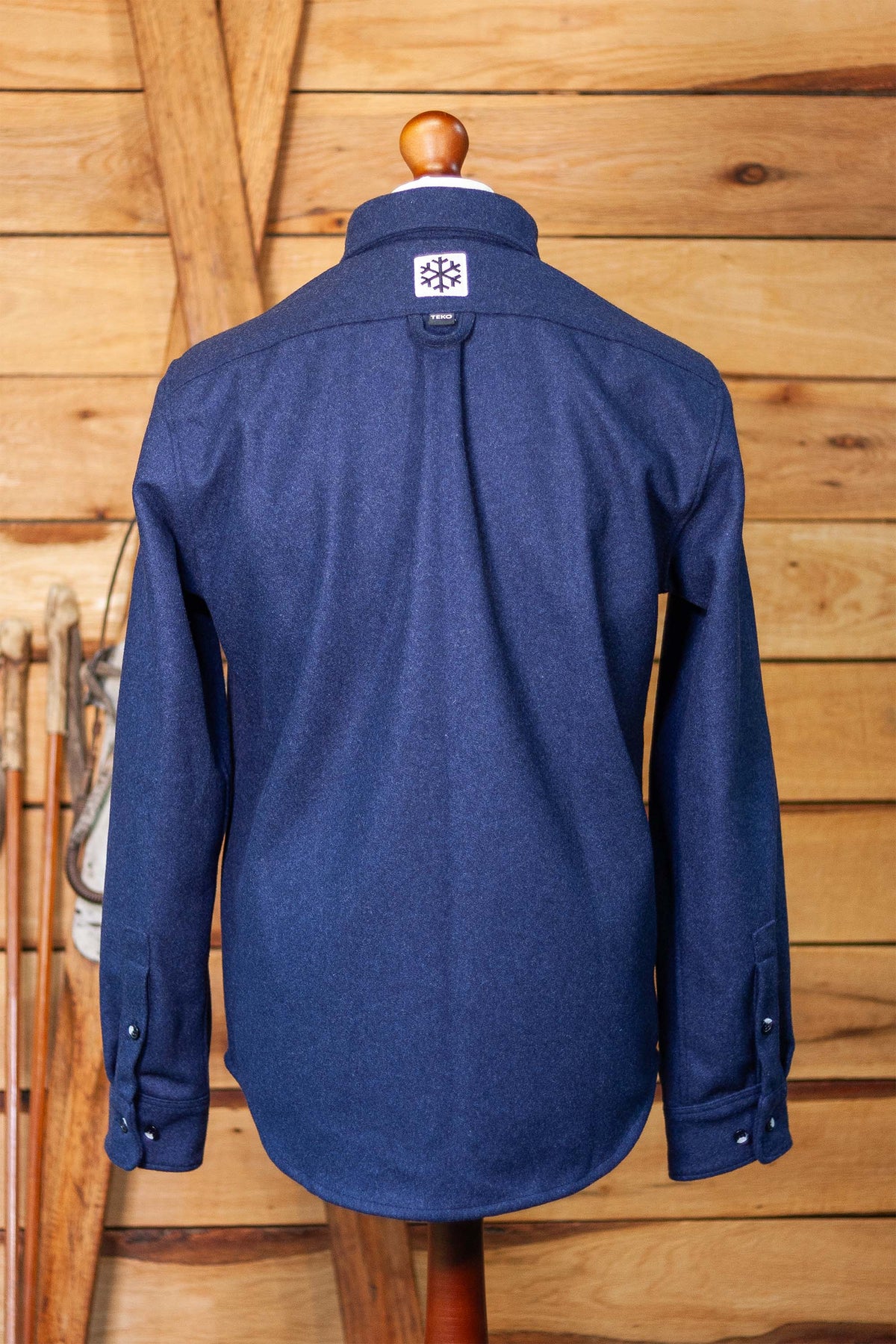 Back view of the TEKO x POW Fraser Shacket with snowflake yoke patch and curved hem