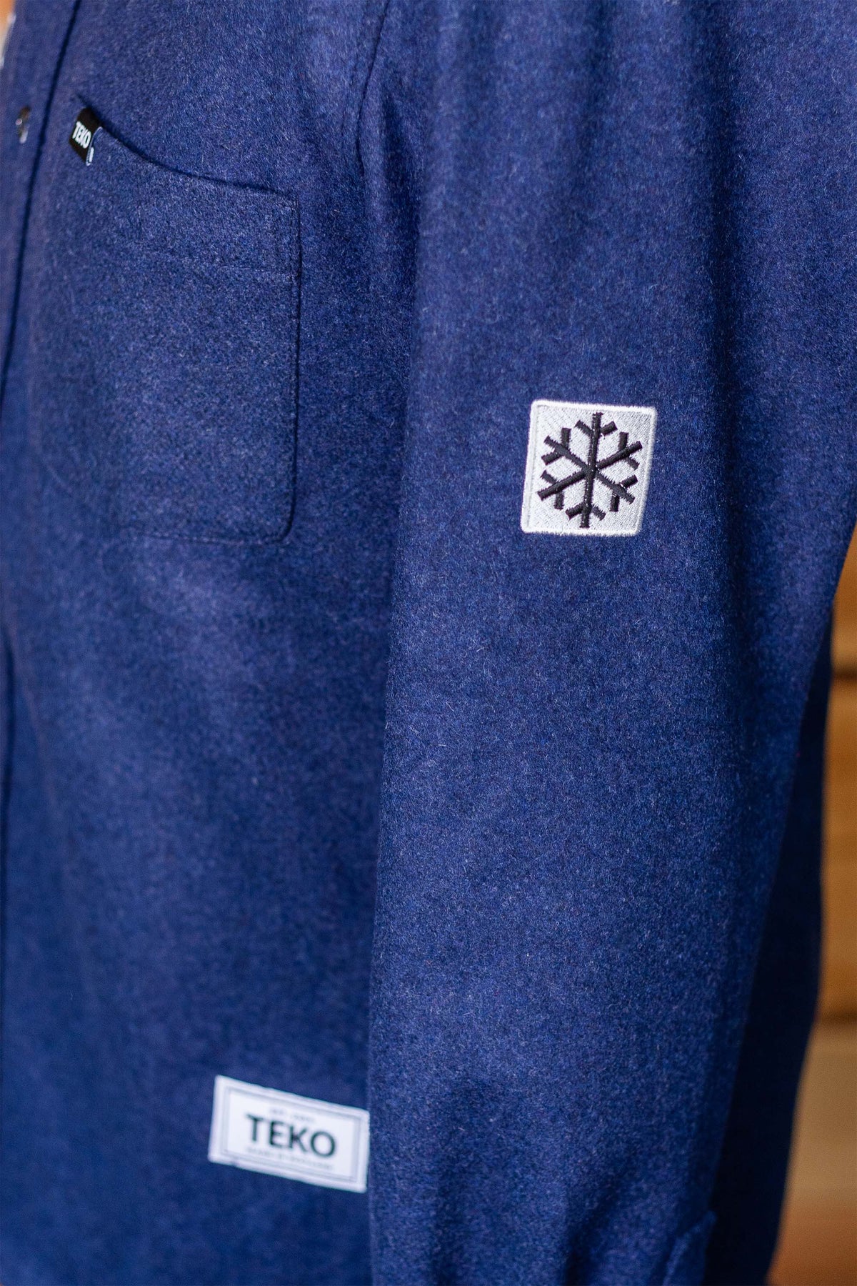 Close-up of the snowflake sleeve patch and TEKO label on Melton 2.0 wool