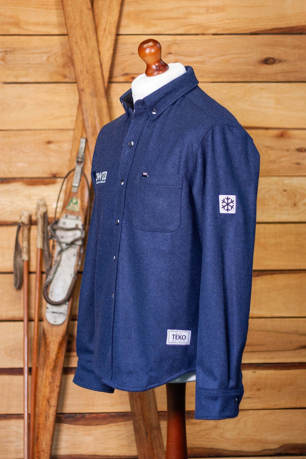 Fraser Shacket three-quarter view showing the snowflake sleeve patch and TEKO hem label