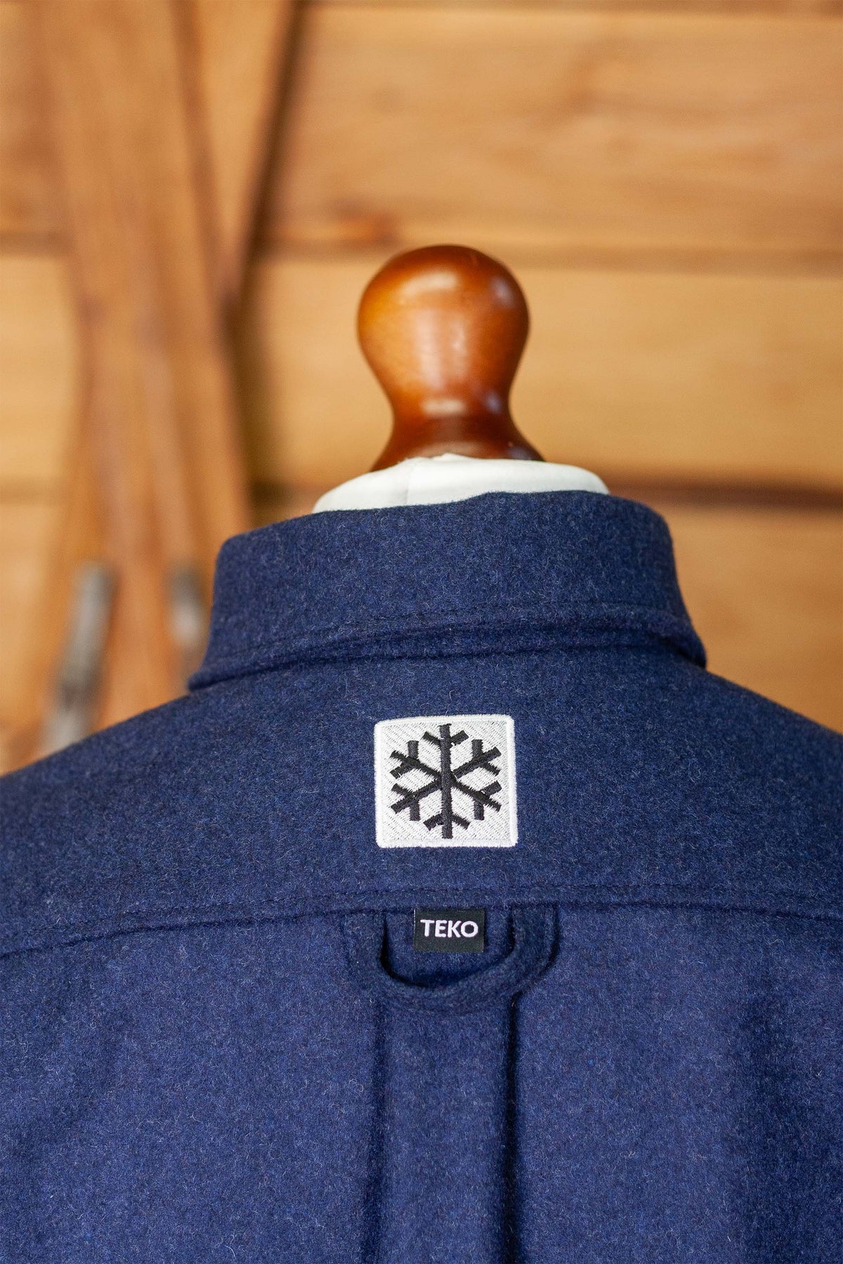 Close-up of the snowflake patch and TEKO hanging loop on the back yoke